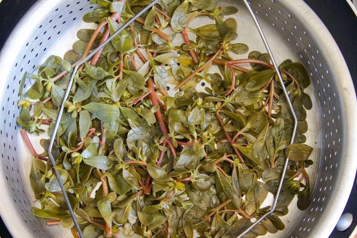 steamed purslane in a steamer basket