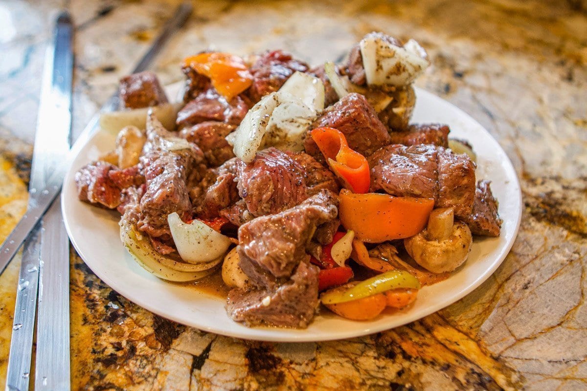raw shish kabob meat and vegetables on plate