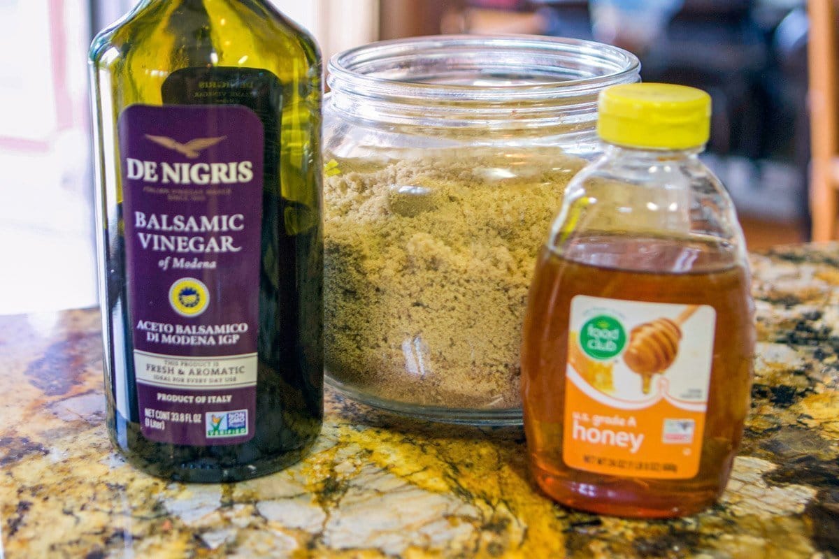 balsamic vinegar, brown sugar, and a jar of honey on a counter