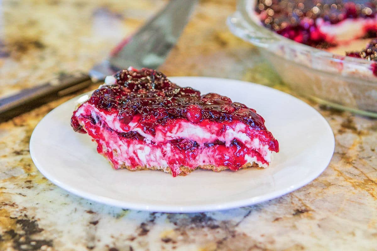 berry cheesecake slice on a white plate