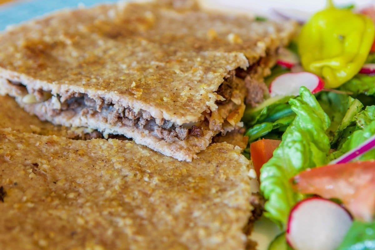 kubba mosul on a plate with a salad