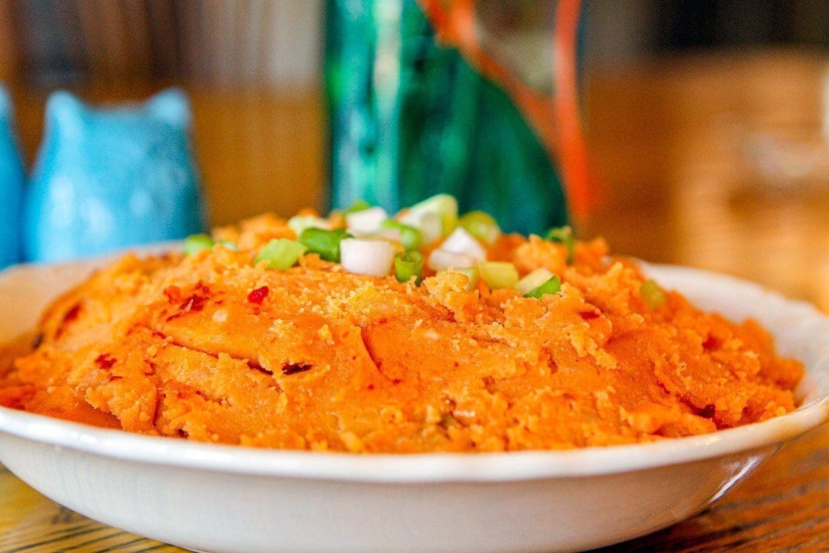 Merchanos, mashed potatoes in a white bowl on a blue placemat