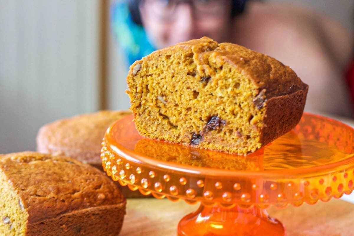 sliced pumpkin bread on an orange stand