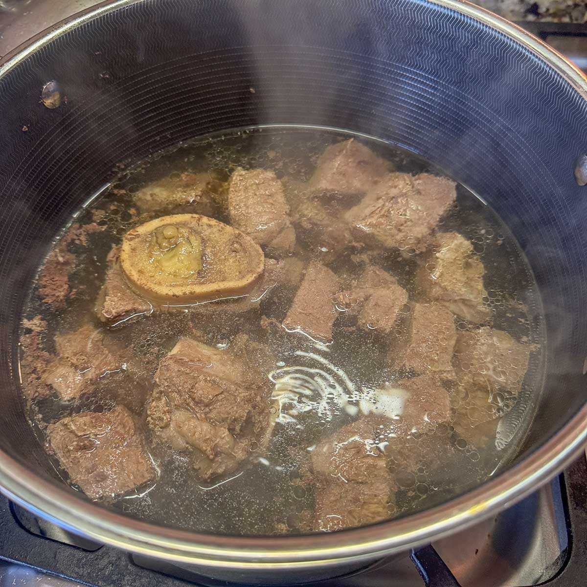 meat cooking in a pot of water