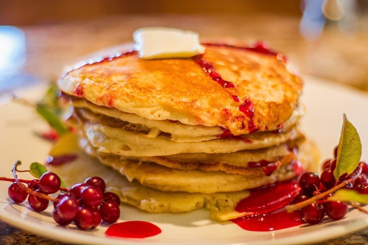 pancakes topped with chokecherry syrup and a dab of butter