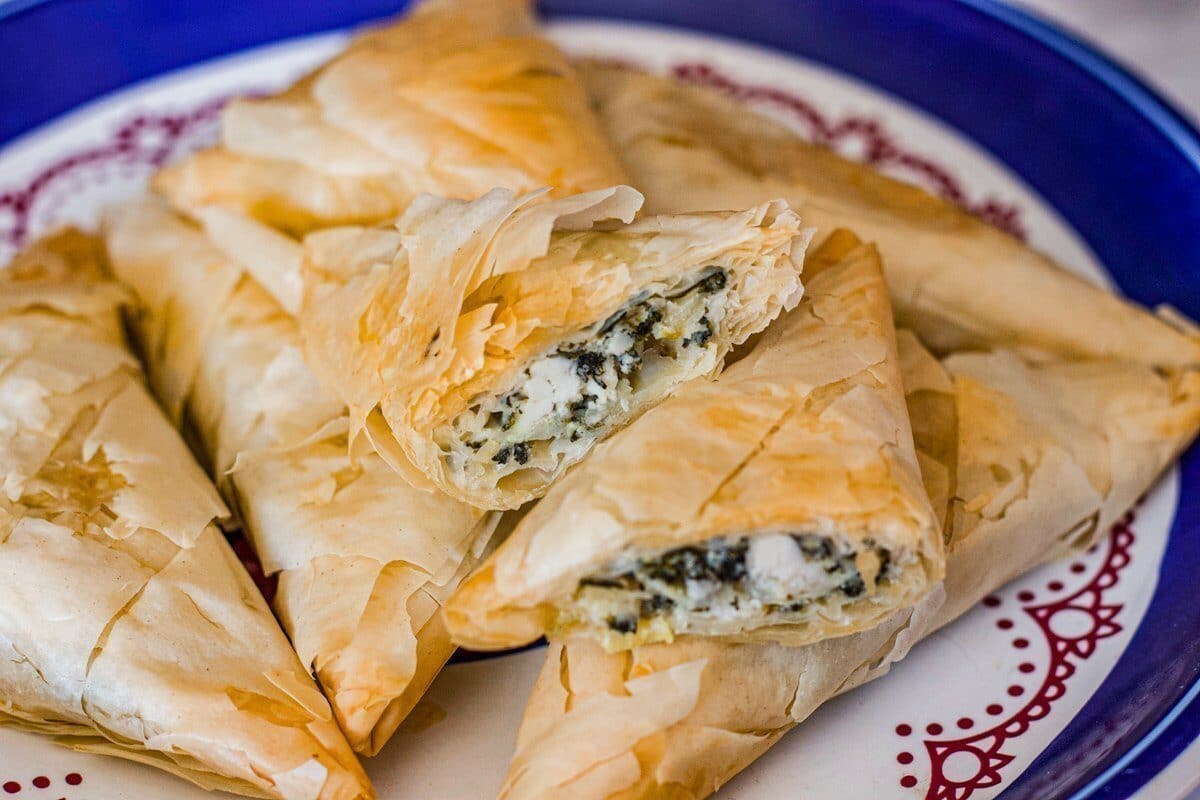 spanakopita on a plate with filling visible