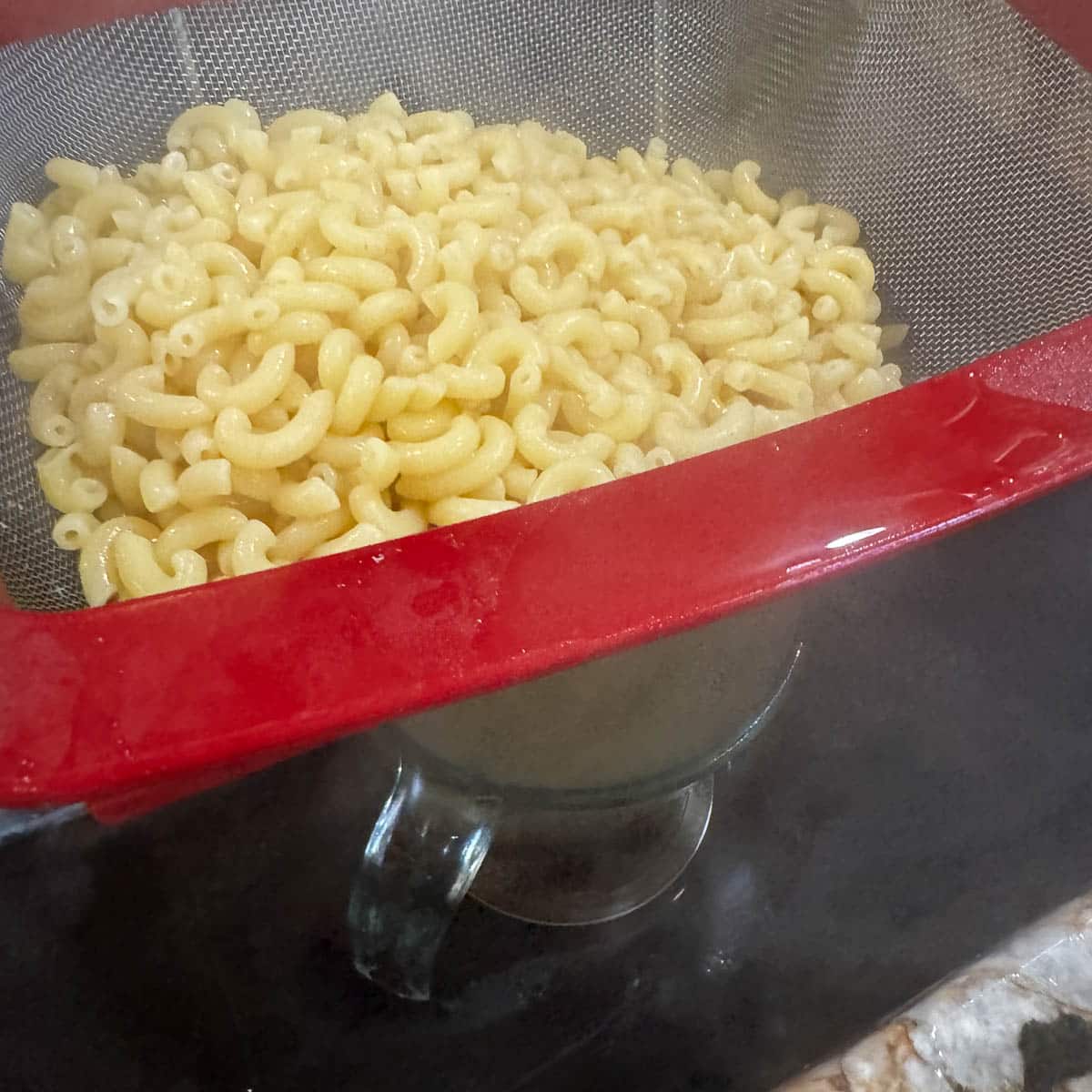 paste being strained in a colander. 