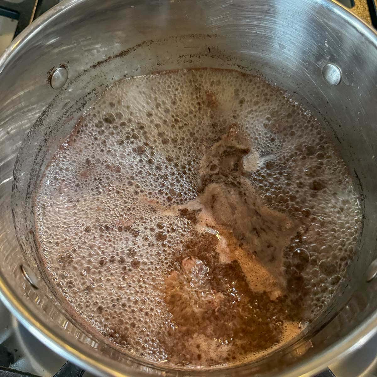 diced meat boiling in a pot.