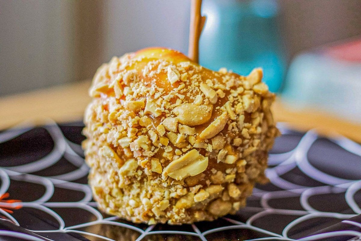 caramel apple on a black spiderweb plate