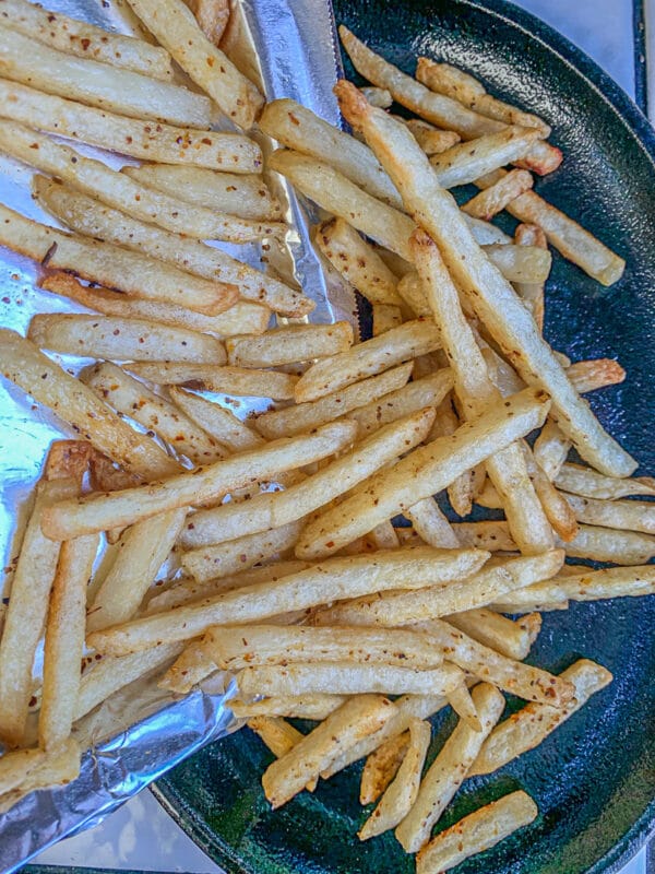 fries being added to a pan