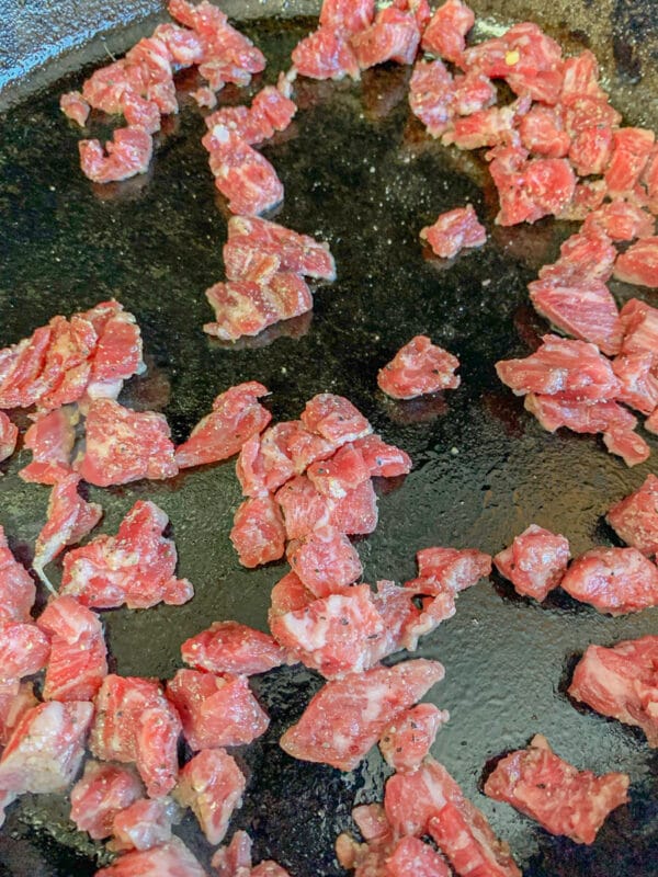 raw diced meat in a pan