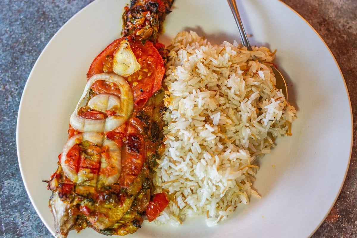 rice and fish on a white plate