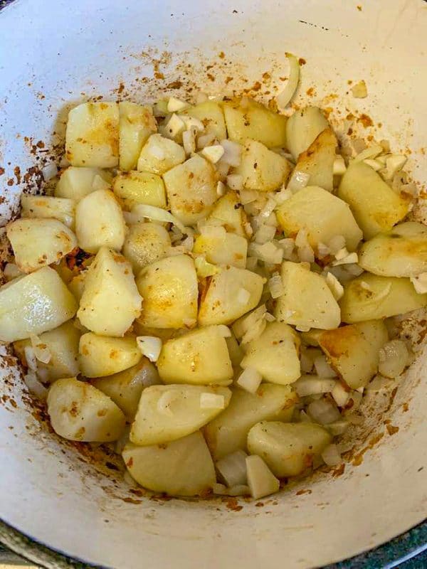 diced potatoes and onions in a pot being cooked