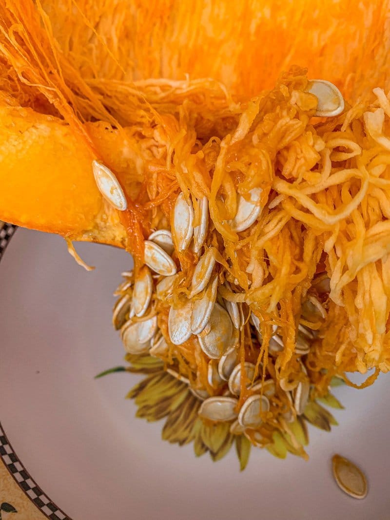 seeds being taken out of a pumpkin