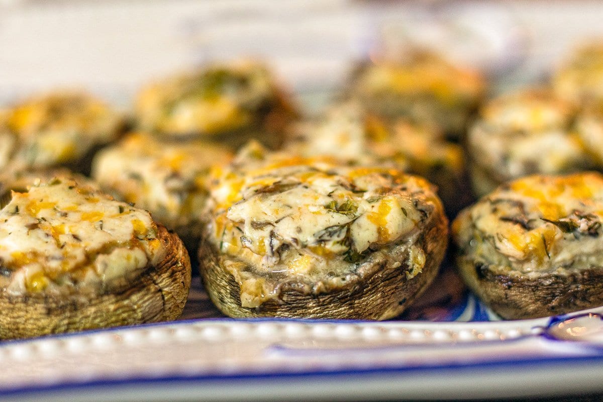 stuffed mushrooms on a blue and white dish