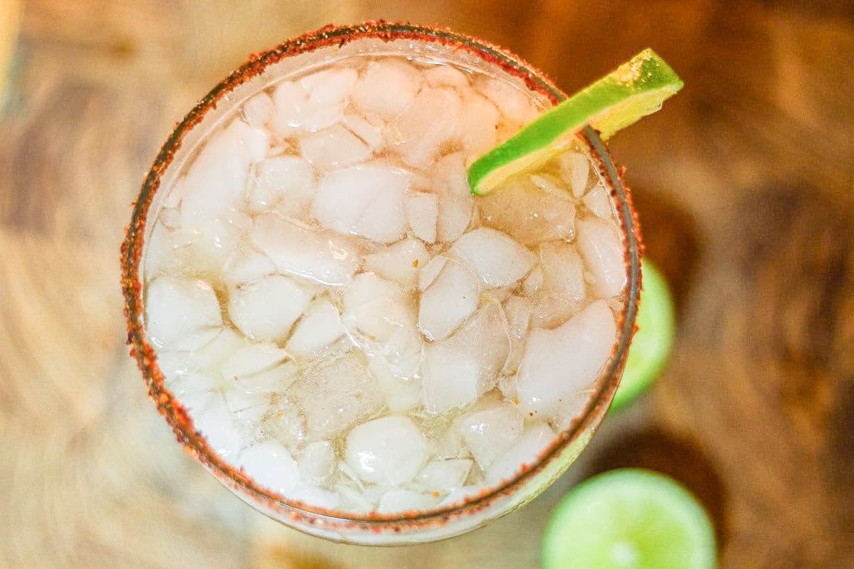 tamarind margarita with lots of ice and a slice of lime for garnish.