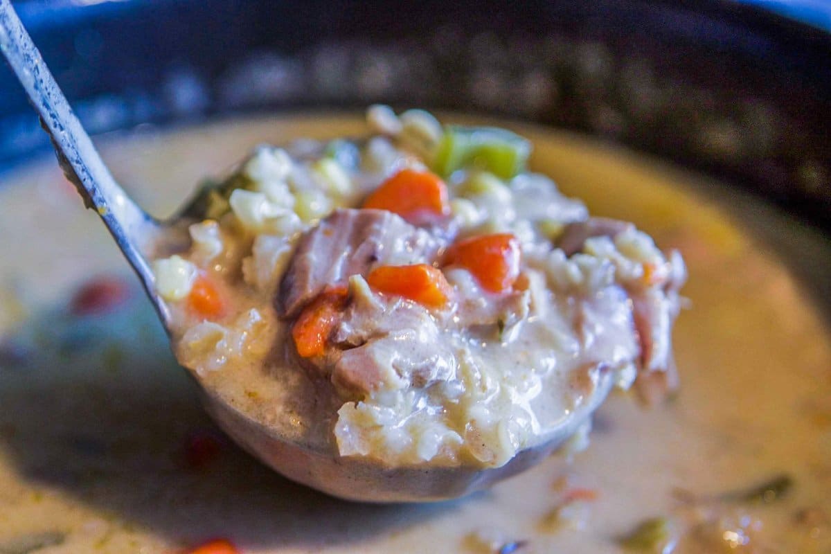 turkey soup being spooned with a large ladle