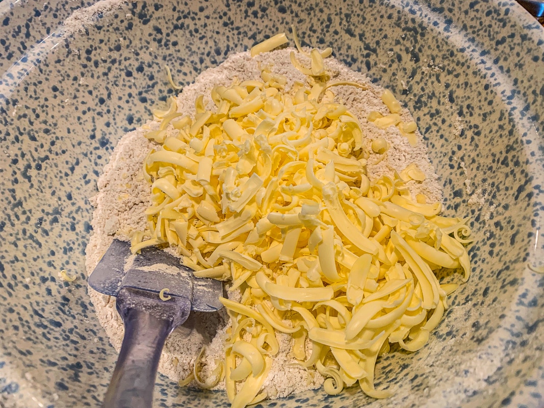 grated butter in a blue bowl