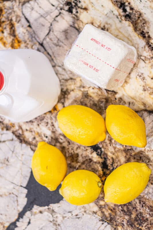 milk, butter and lemons on a marbled counter