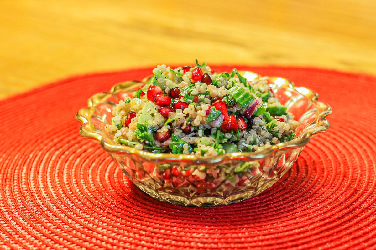 quinoa salad in a bowl over a red mat