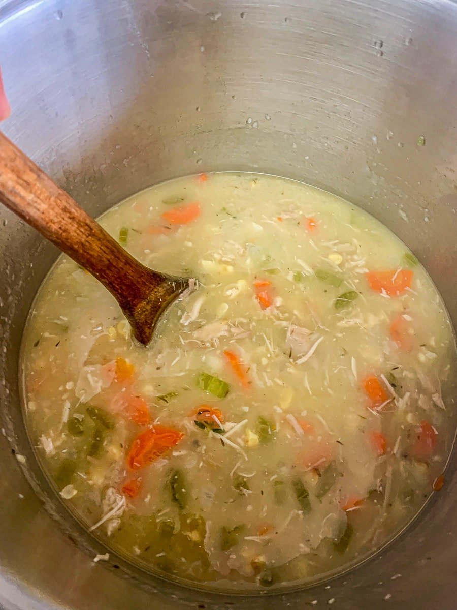 turkey soup being stirred in a pot