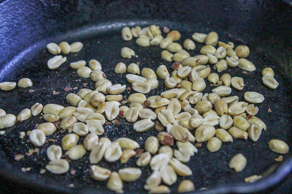 peanuts being toasted in a pan