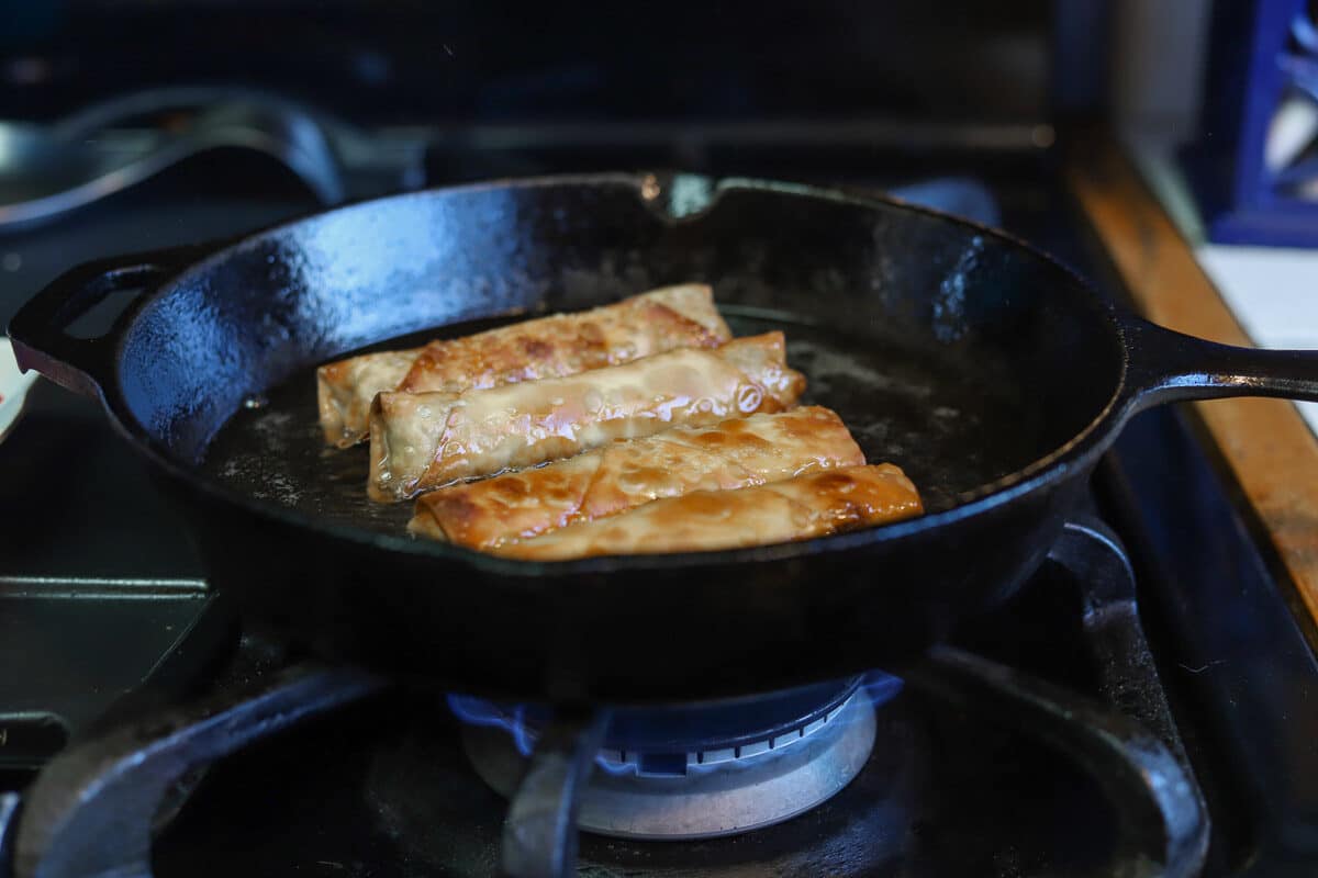 lumpia being fried in a pan