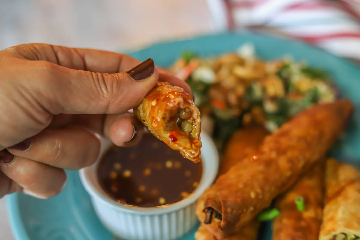 dipping lumpia in chili sauce