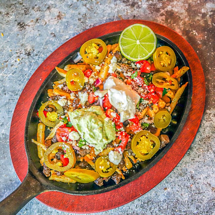 New Years eve appetizers: loaded Carne Asada fries on a pan