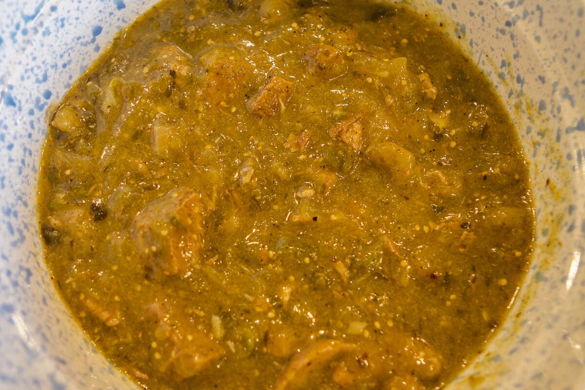 chili verde in a blue and white bowl