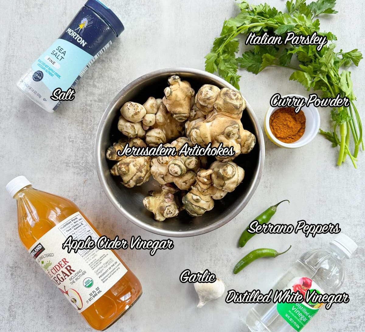 pickled artichoke recipe ingredients including Jerusalem artichokes, vinegar, peppers, garlic, and spices.