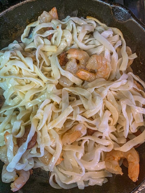 protein noodles in a pan with shrimp and sausage