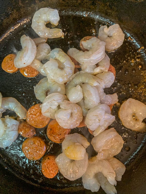 shrimp and sliced sausage in a pan