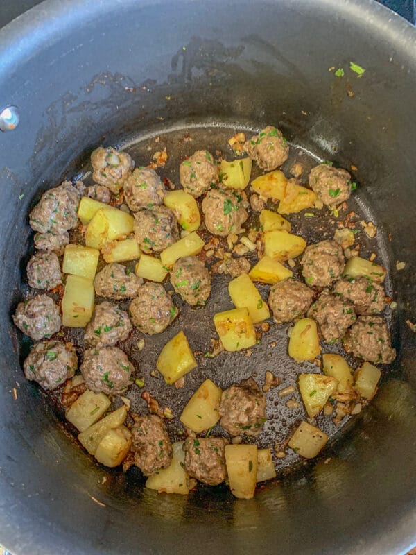 potatoes and mini meatballs cooking in a pot