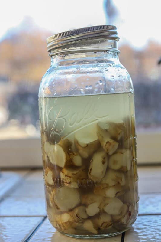 sunchokes in a jar being brined