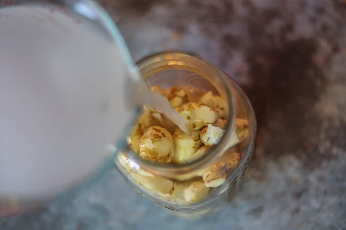 brine being poured over sunchokes