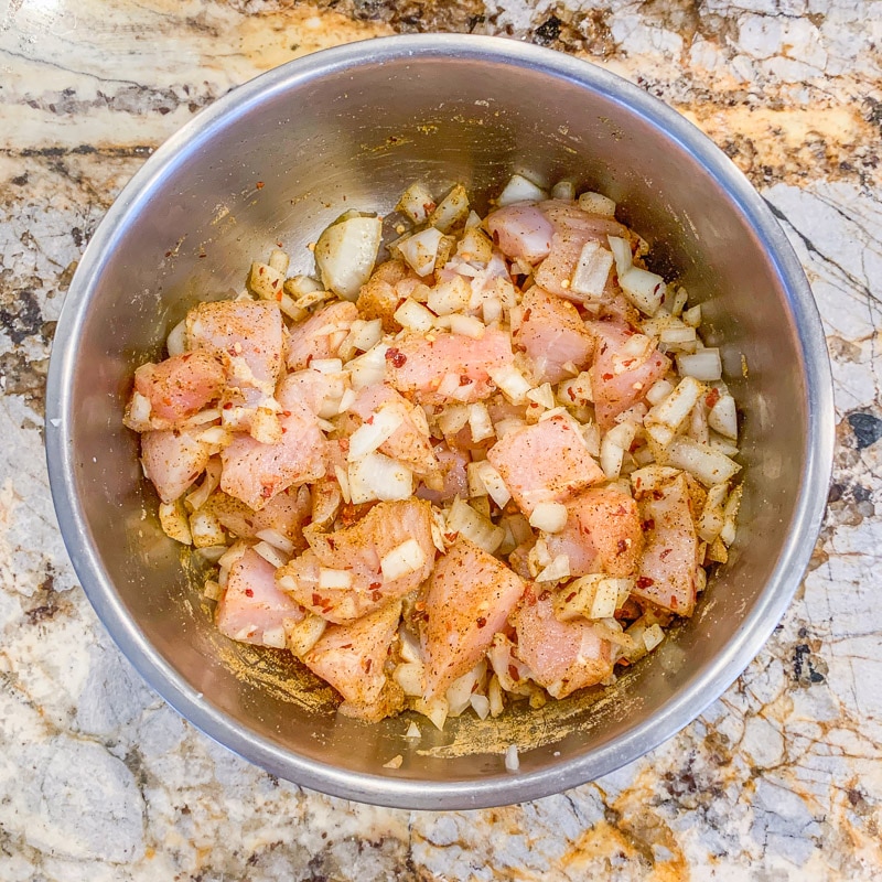 chopped chicken and onions in a bowl