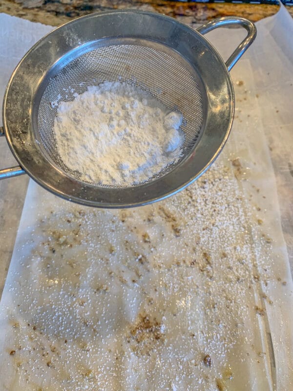 fillo dough being sprinkled with powdered sugar