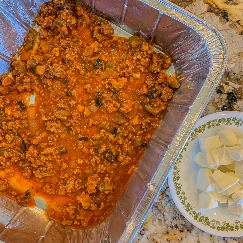 lasagna pan with meaty pasta sauce in it