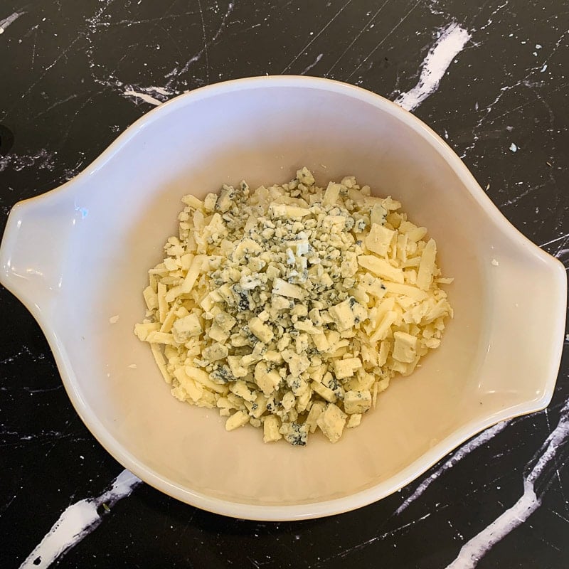 grated white cheese and gorgonzola in a white bowl