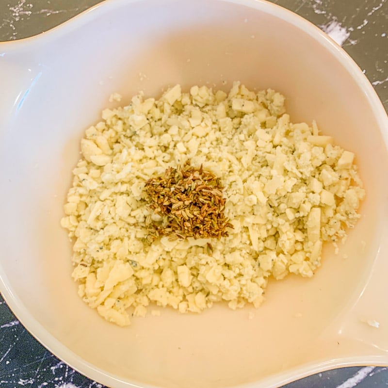 asiago cheese in a bowl with seeds on to