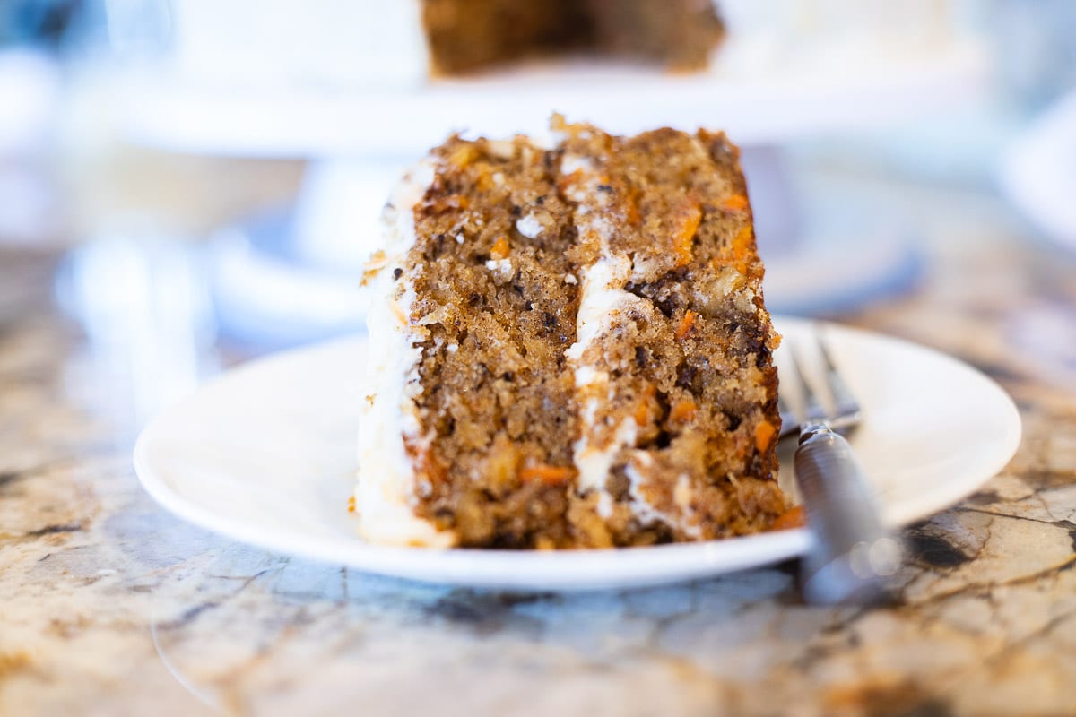 carrot cake with pineapple on a white place with a fork