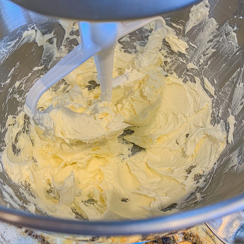 mixing frosting in a silver bowl