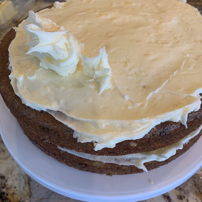 carrot cake with pineapple on a cake stand