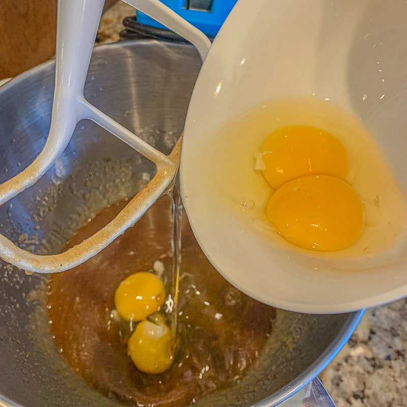 pouring eggs into mixing bowl