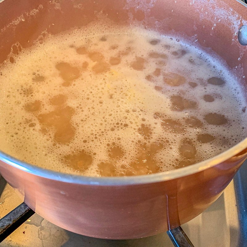 lentil covered in liquid boiling in a pot: red lentil recipes: