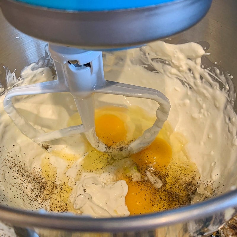 mixing bowl with cream cheese and eggs