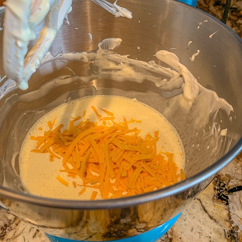 mixing bowl with cream and shredded cheddar cheese