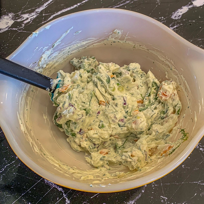 veggies and cream cheese mixed in a bowl