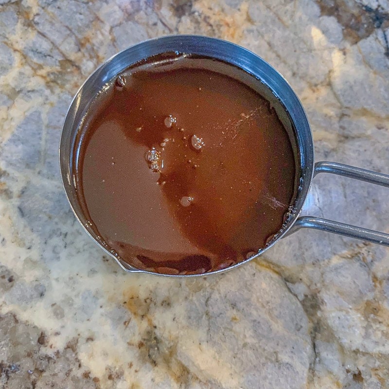 date syrup in a measuring cup